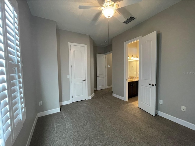 unfurnished bedroom featuring ceiling fan and dark colored carpet