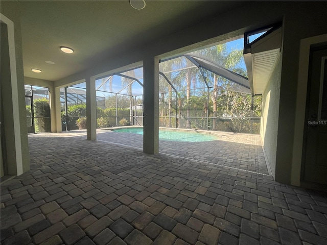 view of patio / terrace featuring glass enclosure