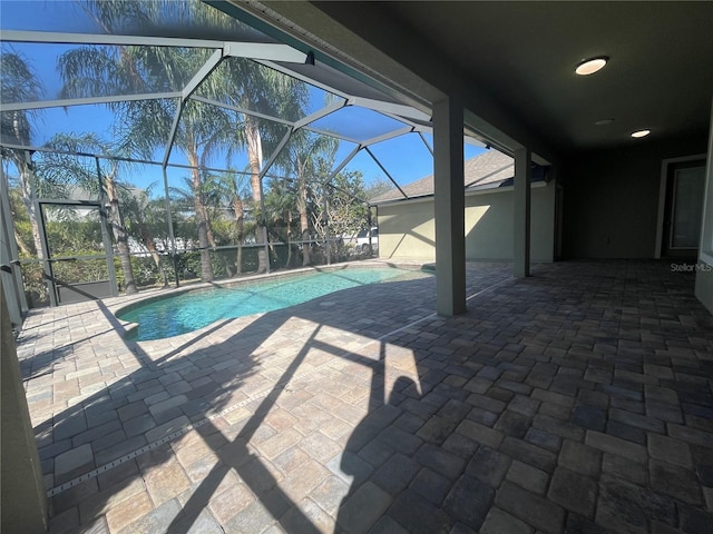 view of pool with a patio and a lanai