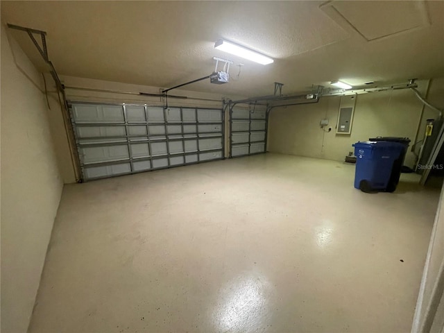 garage with a garage door opener and electric panel