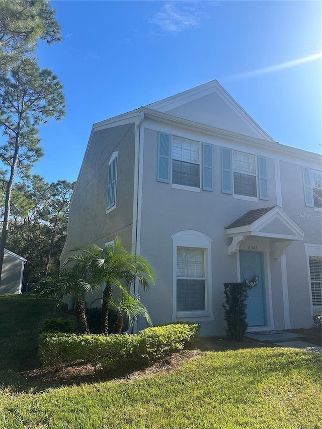 view of property exterior with a lawn