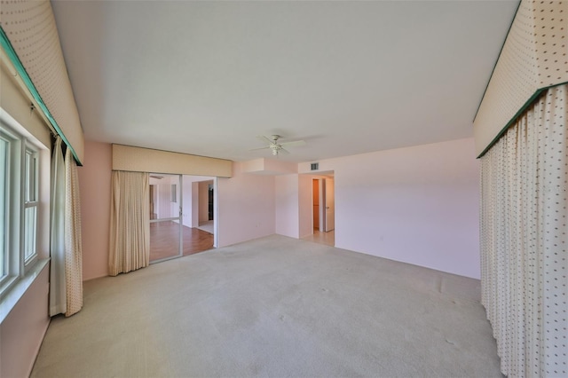 unfurnished bedroom featuring ceiling fan and light colored carpet