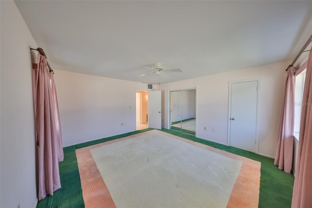 unfurnished bedroom featuring ceiling fan and carpet flooring