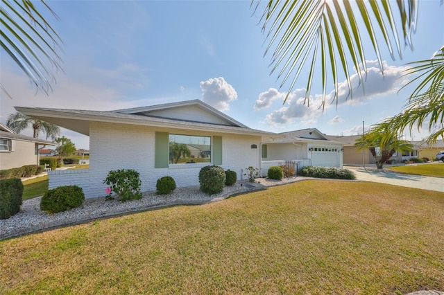 ranch-style house with a garage and a front lawn