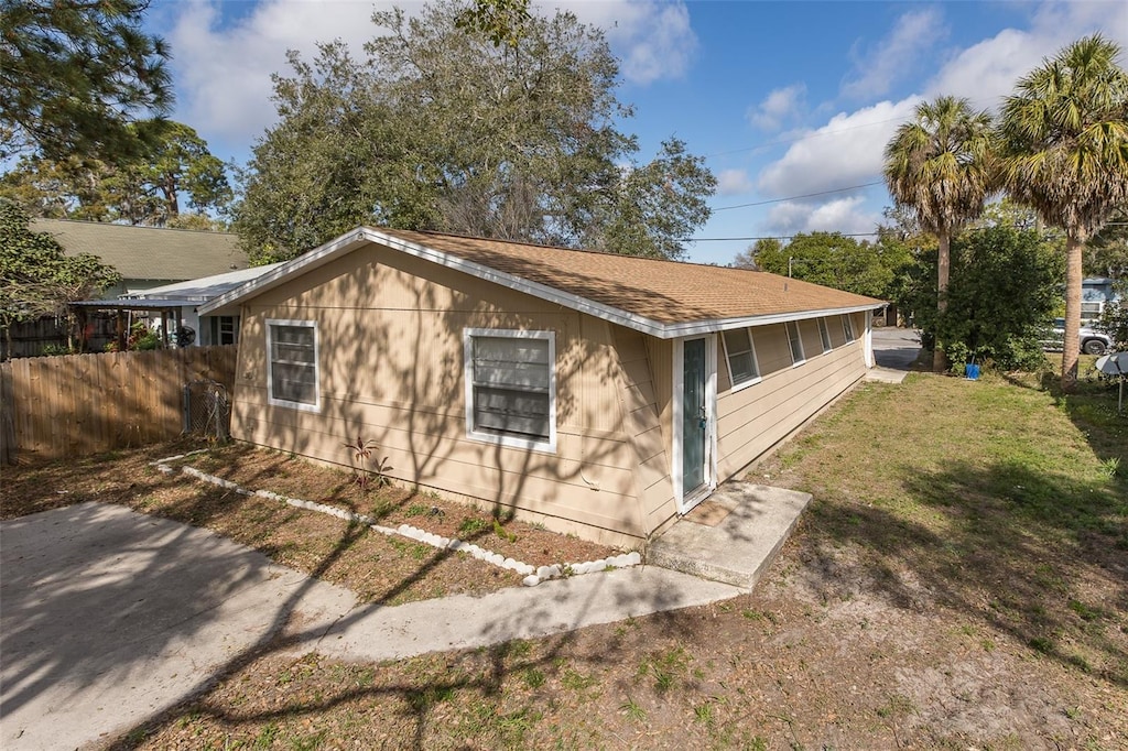 view of property exterior with a yard