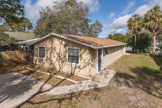 view of property exterior with a yard