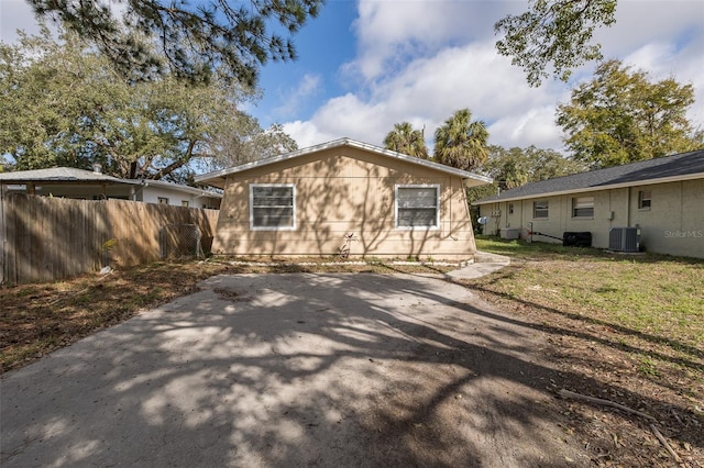 rear view of property featuring central AC and a patio area