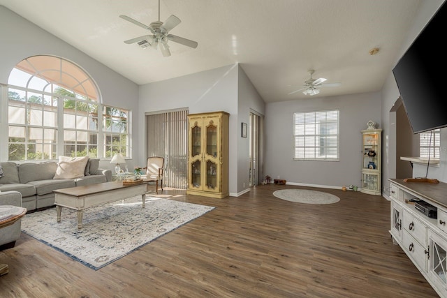 living area with visible vents, baseboards, dark wood finished floors, lofted ceiling, and ceiling fan