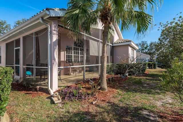 view of side of home featuring a patio area and stucco siding