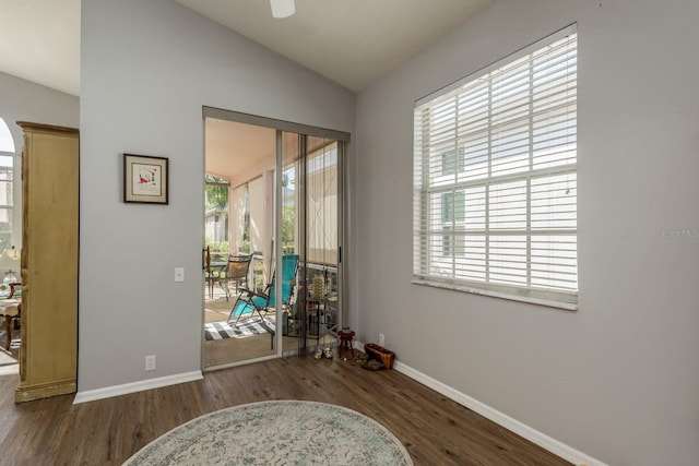 interior space with a wealth of natural light, dark wood finished floors, and lofted ceiling