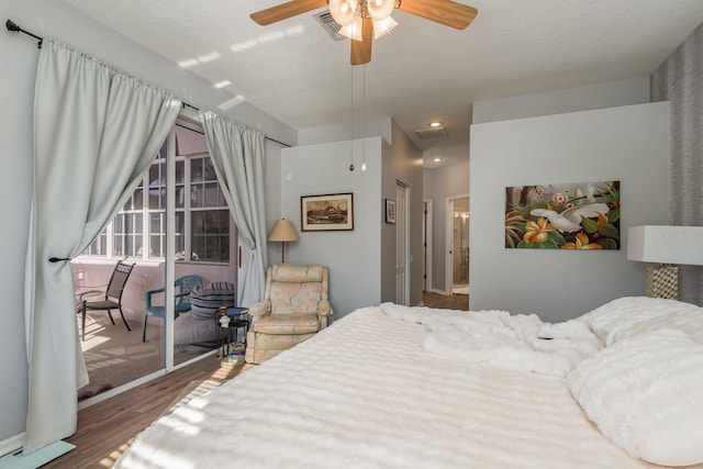 bedroom featuring a textured ceiling, a ceiling fan, and wood finished floors