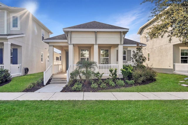 view of front of house featuring a front lawn and covered porch