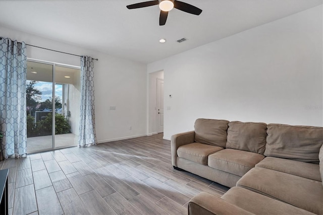 unfurnished living room featuring ceiling fan and light wood-type flooring