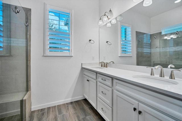 bathroom with vanity, an enclosed shower, and hardwood / wood-style floors