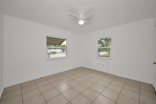 unfurnished room with ceiling fan and a healthy amount of sunlight