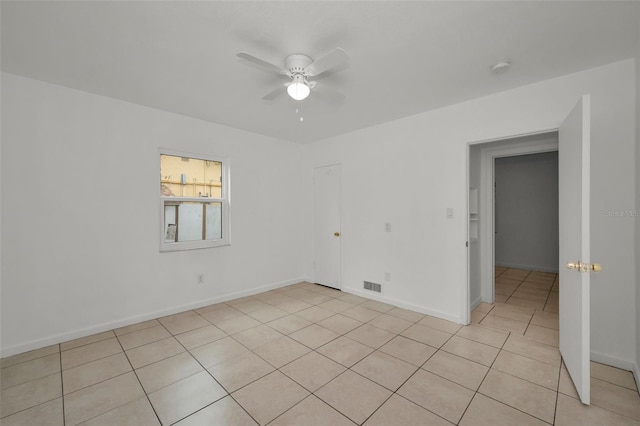 unfurnished room with light tile patterned floors and ceiling fan