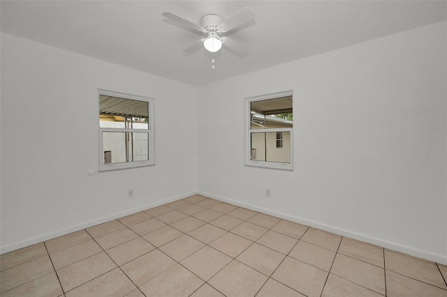 spare room with a wealth of natural light and ceiling fan