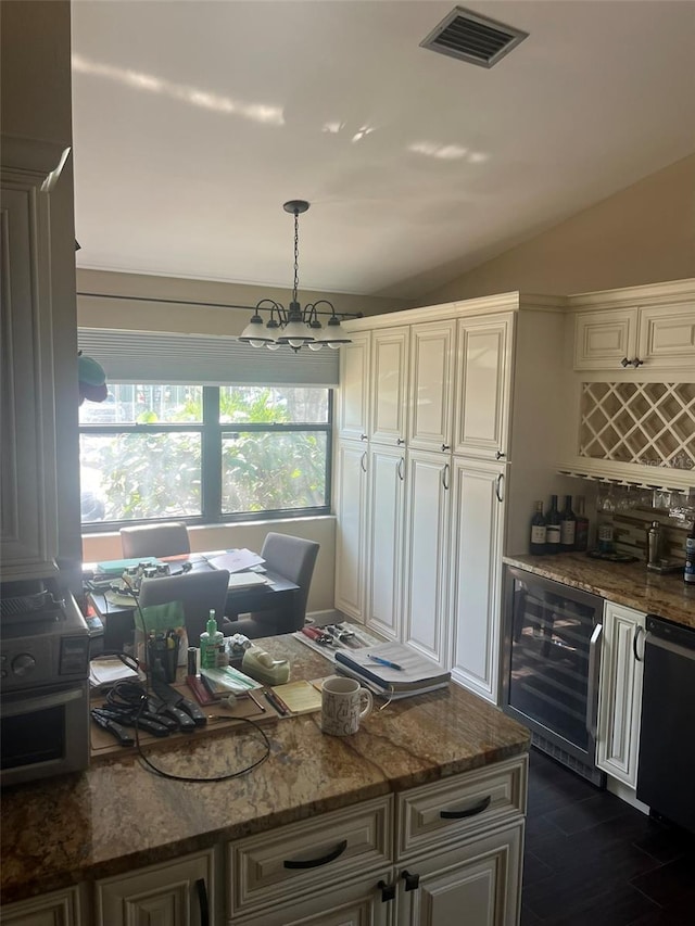 kitchen featuring pendant lighting, dark stone countertops, black dishwasher, vaulted ceiling, and beverage cooler