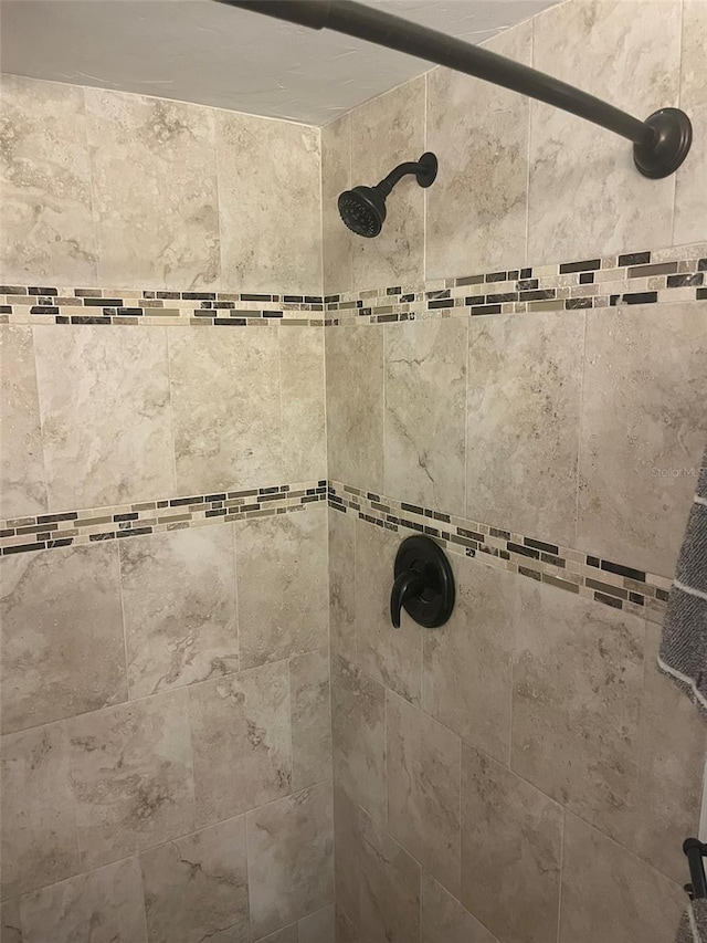 bathroom with a tile shower