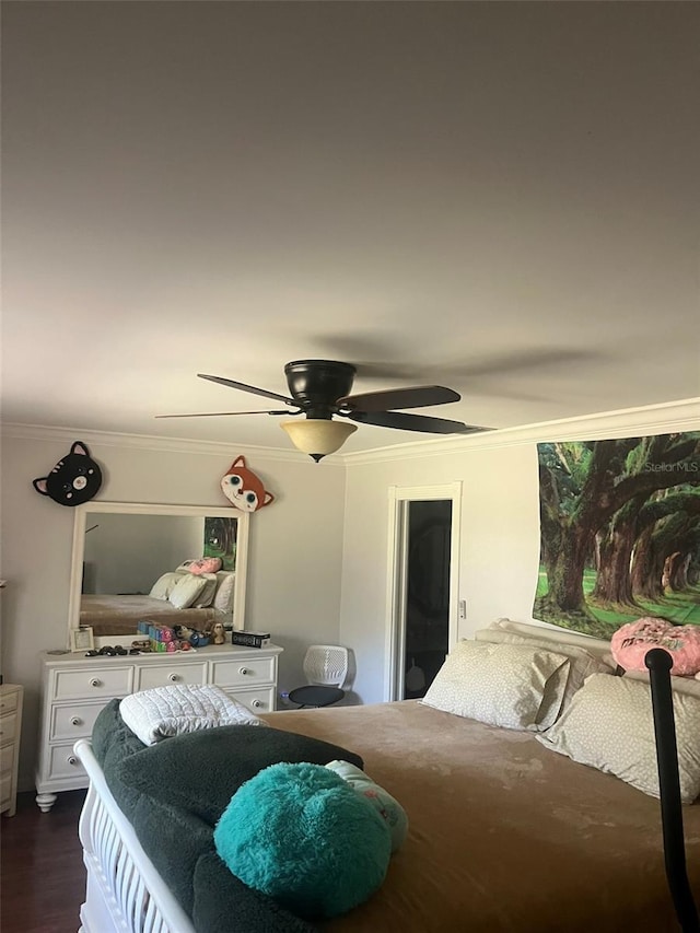 bedroom with ornamental molding, dark hardwood / wood-style floors, and ceiling fan