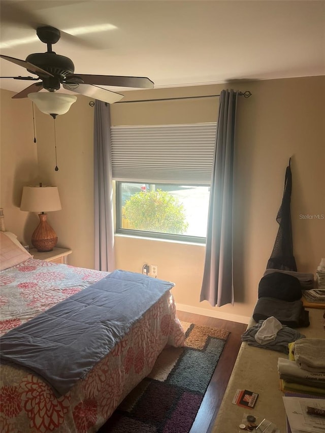 bedroom with dark hardwood / wood-style floors