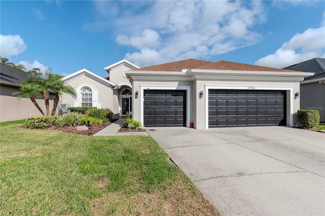 ranch-style home featuring a garage and a front lawn