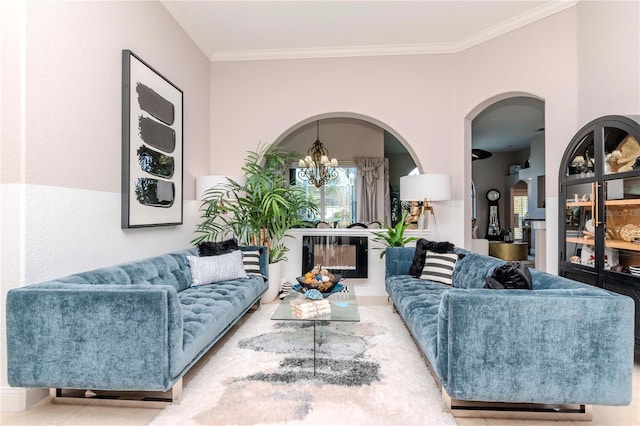 living room with ornamental molding and a notable chandelier