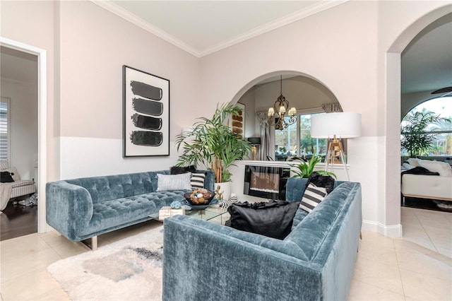 living room featuring crown molding, light tile patterned flooring, and an inviting chandelier