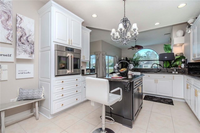 kitchen featuring white cabinetry, a kitchen island, and light tile patterned flooring