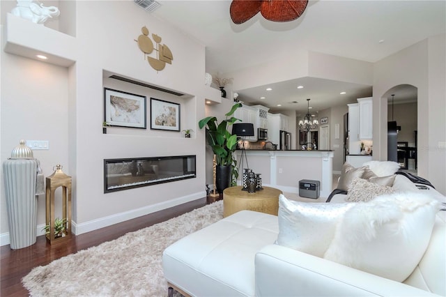 living room featuring dark hardwood / wood-style floors and a notable chandelier