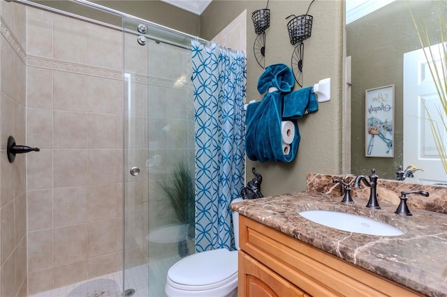 bathroom with vanity, toilet, and a tile shower