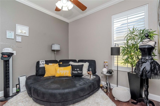 sitting room with hardwood / wood-style floors, a wealth of natural light, ornamental molding, and ceiling fan