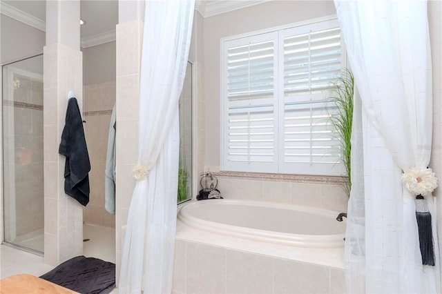 bathroom featuring ornamental molding and separate shower and tub