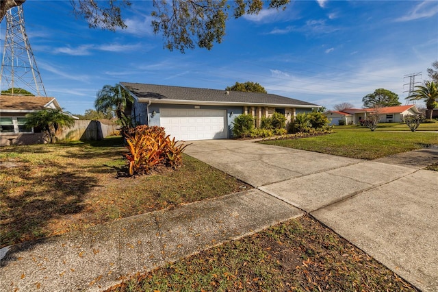 single story home featuring a garage and a front yard