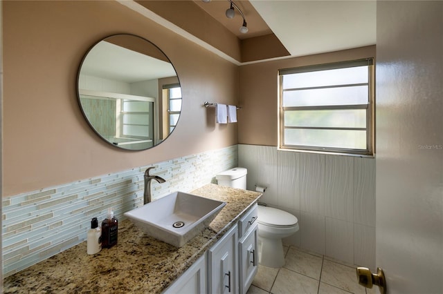 bathroom with tile patterned flooring, vanity, and toilet