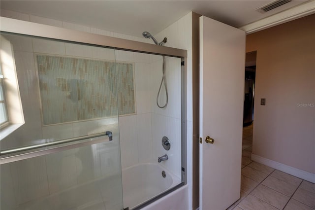 bathroom with tile patterned flooring and combined bath / shower with glass door