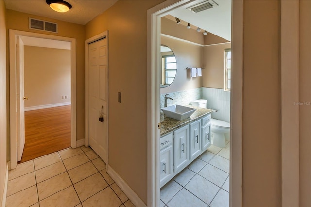 bathroom with vanity, tile patterned floors, and toilet