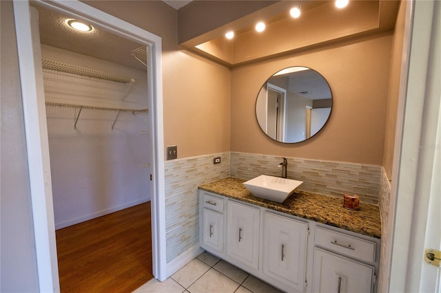 bathroom with vanity, tile walls, and tile patterned floors