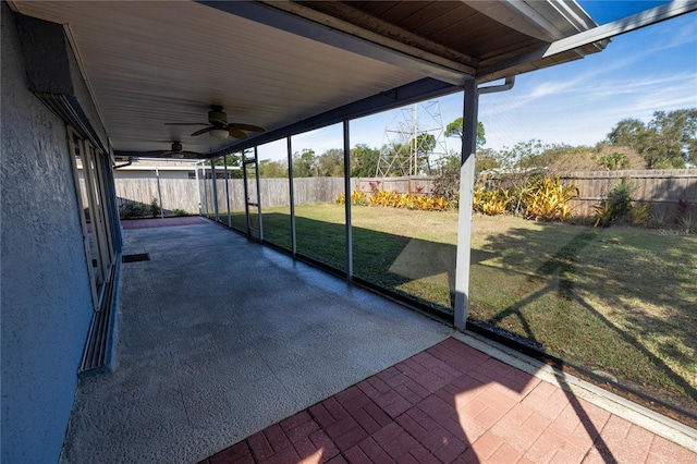 unfurnished sunroom with plenty of natural light and ceiling fan