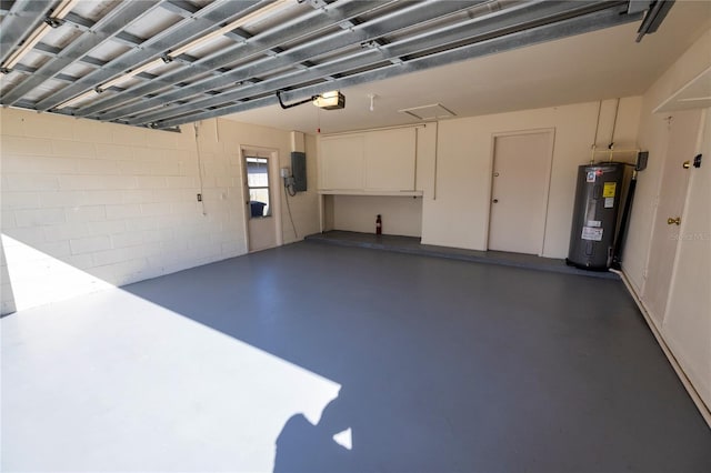 garage featuring a garage door opener, electric panel, and electric water heater