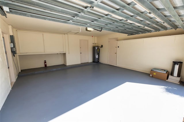 garage featuring a garage door opener and electric water heater