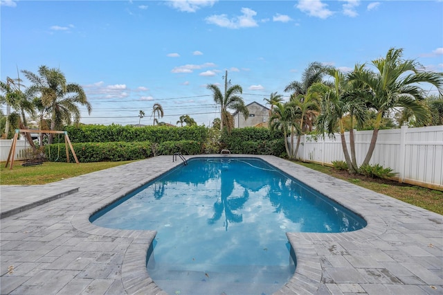 view of pool featuring a patio area and a playground