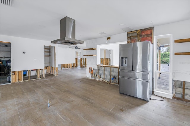 kitchen featuring island range hood and stainless steel fridge