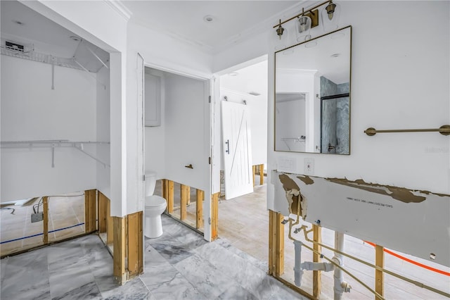 bathroom featuring ornamental molding, toilet, and a shower