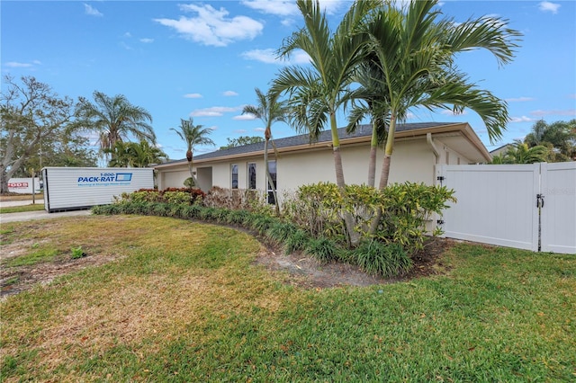 view of property exterior featuring a lawn