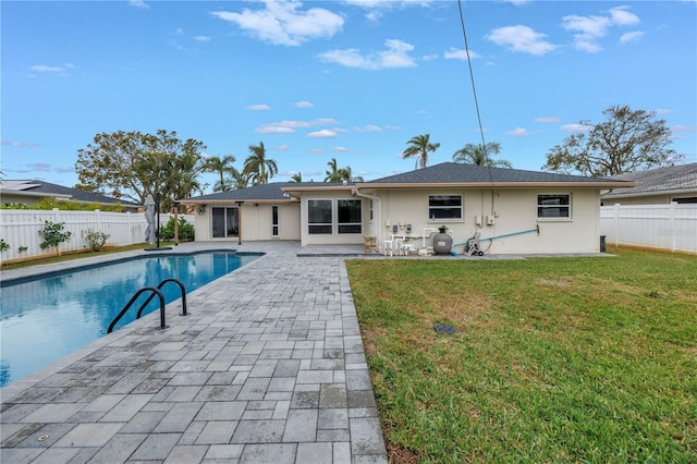 view of swimming pool featuring a patio and a yard