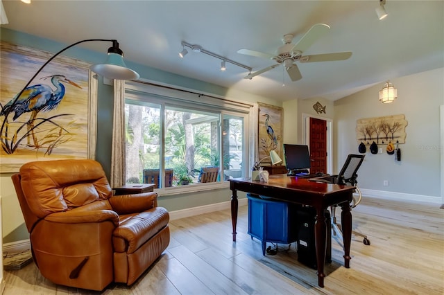 home office with lofted ceiling, light hardwood / wood-style flooring, rail lighting, and ceiling fan