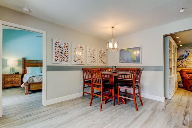 dining room with an inviting chandelier and light hardwood / wood-style floors