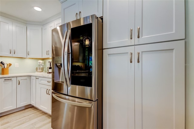 kitchen with white cabinetry, stainless steel refrigerator with ice dispenser, and light wood-type flooring