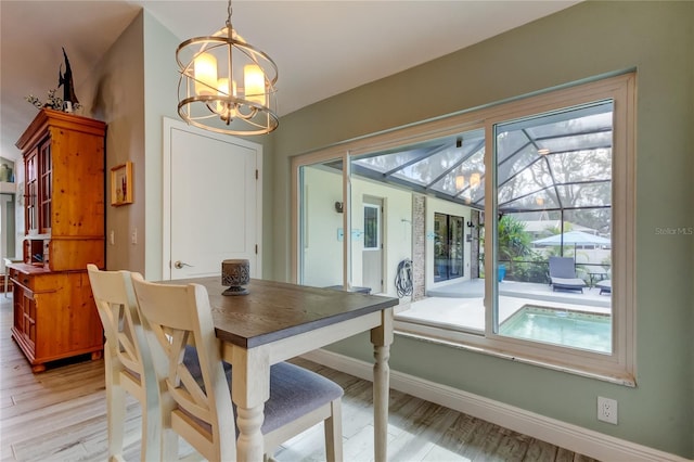 dining room with a chandelier and light wood-type flooring